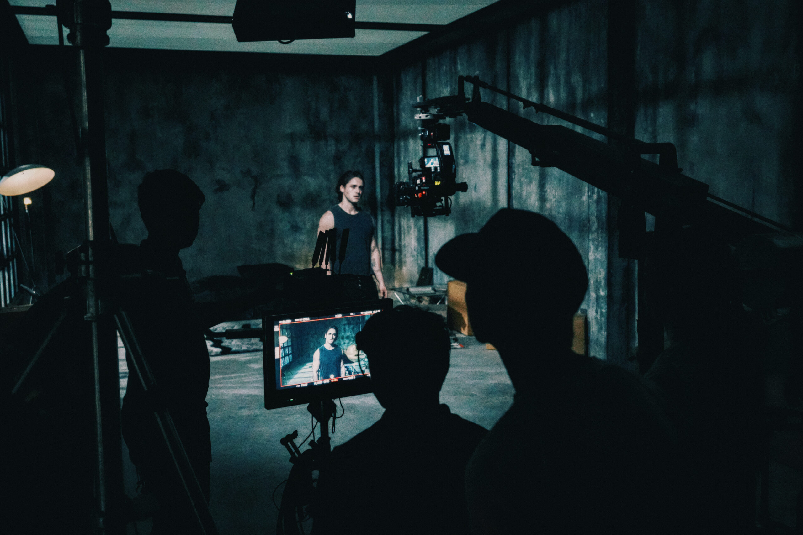 Industrial event space in Bangkok — raw concrete room with considered light at Begrüntes Haus, Phra Khanong