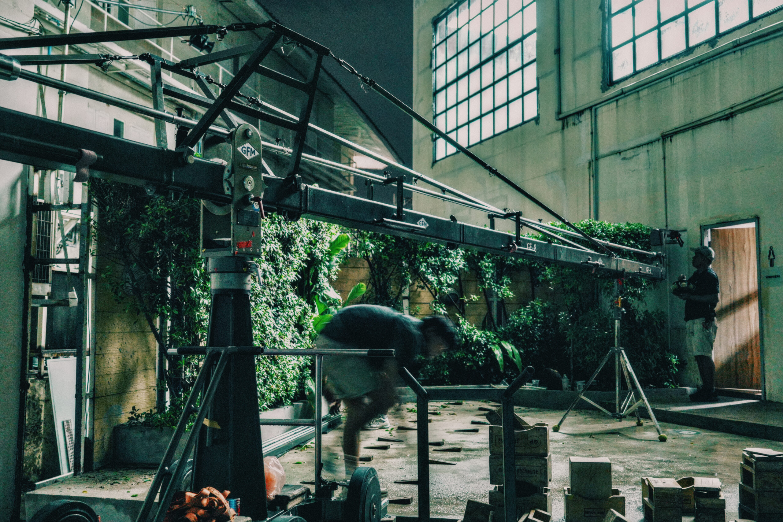 Film screening venue in Bangkok — raw concrete room with considered light at Begrüntes Haus, Phra Khanong